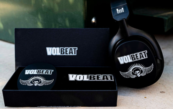 Black heavys headphones with VOLBEAT branding on a concrete surface